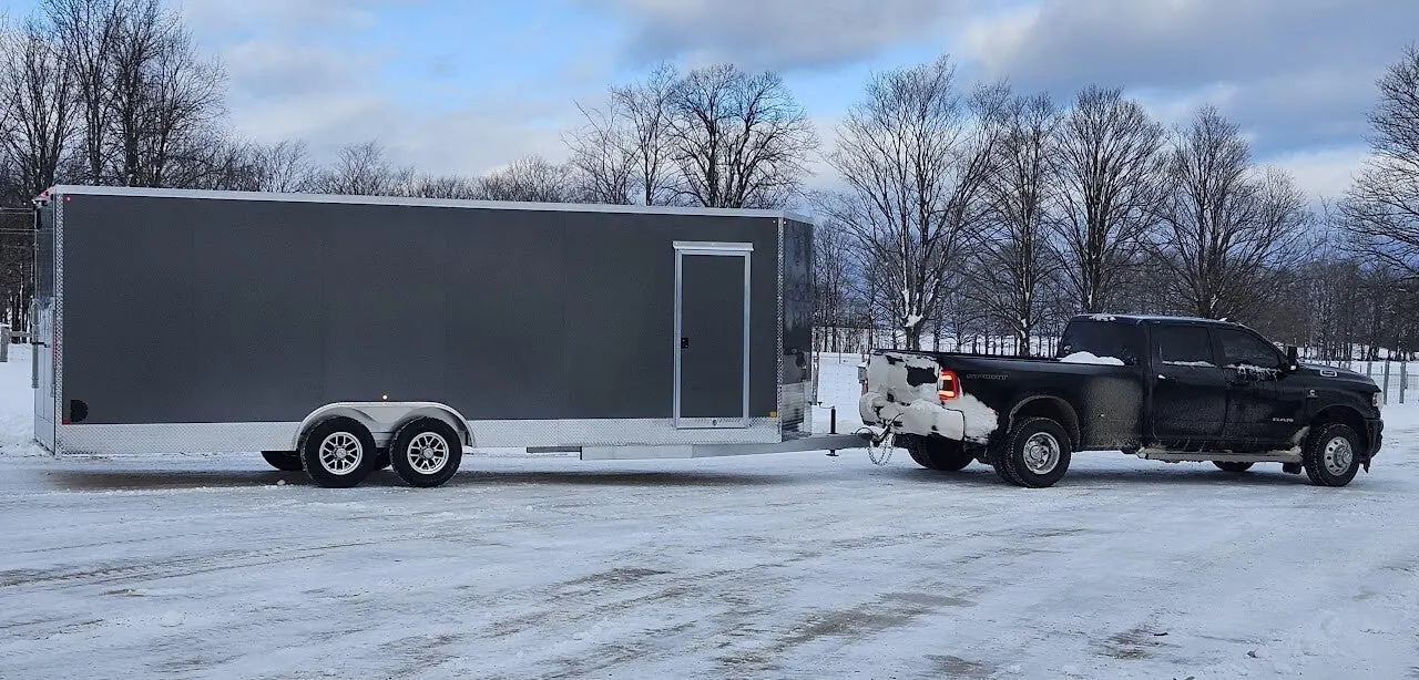 White and red enclosed trailers side by side